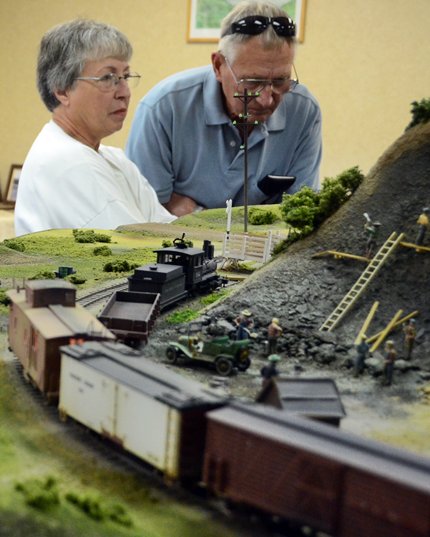 adults looking at a model layout